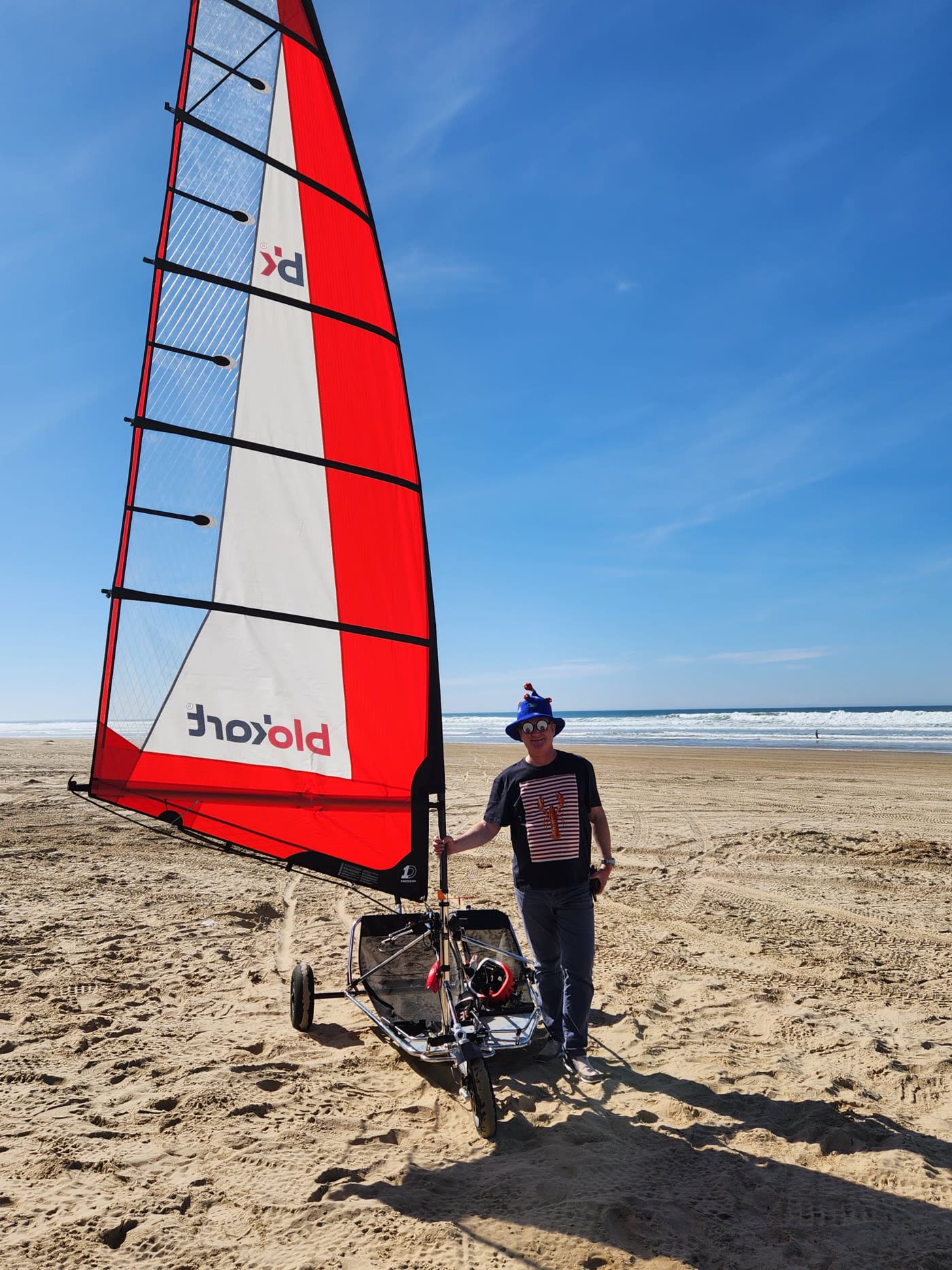 Captain Frantz beside a sail kart on the beach